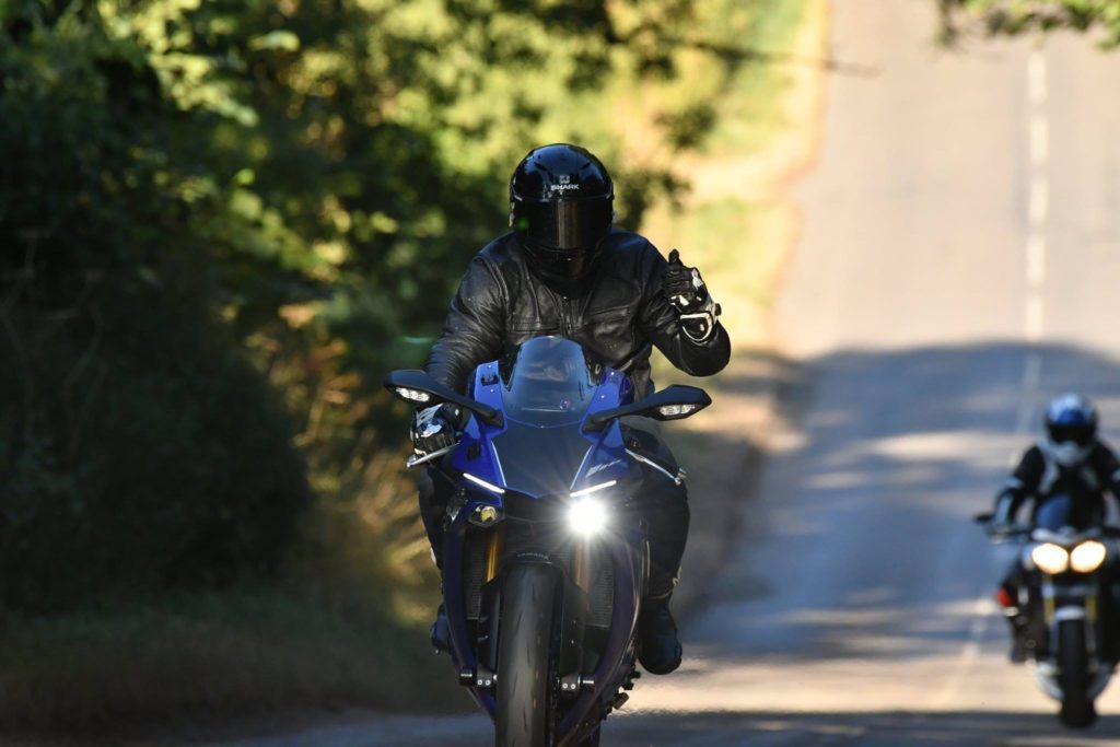 Thumbs up riding motorcycle