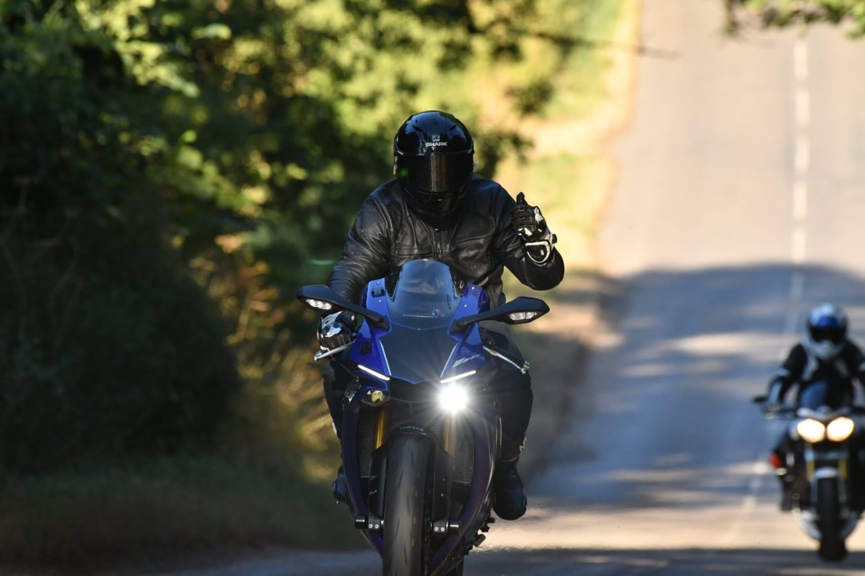 Thumbs up riding motorcycle